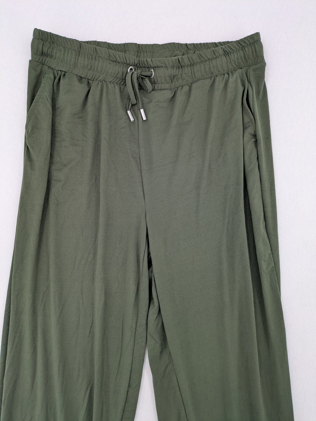 Infinity green jogger pants with elastic waistband and side pockets, soft stretch material.