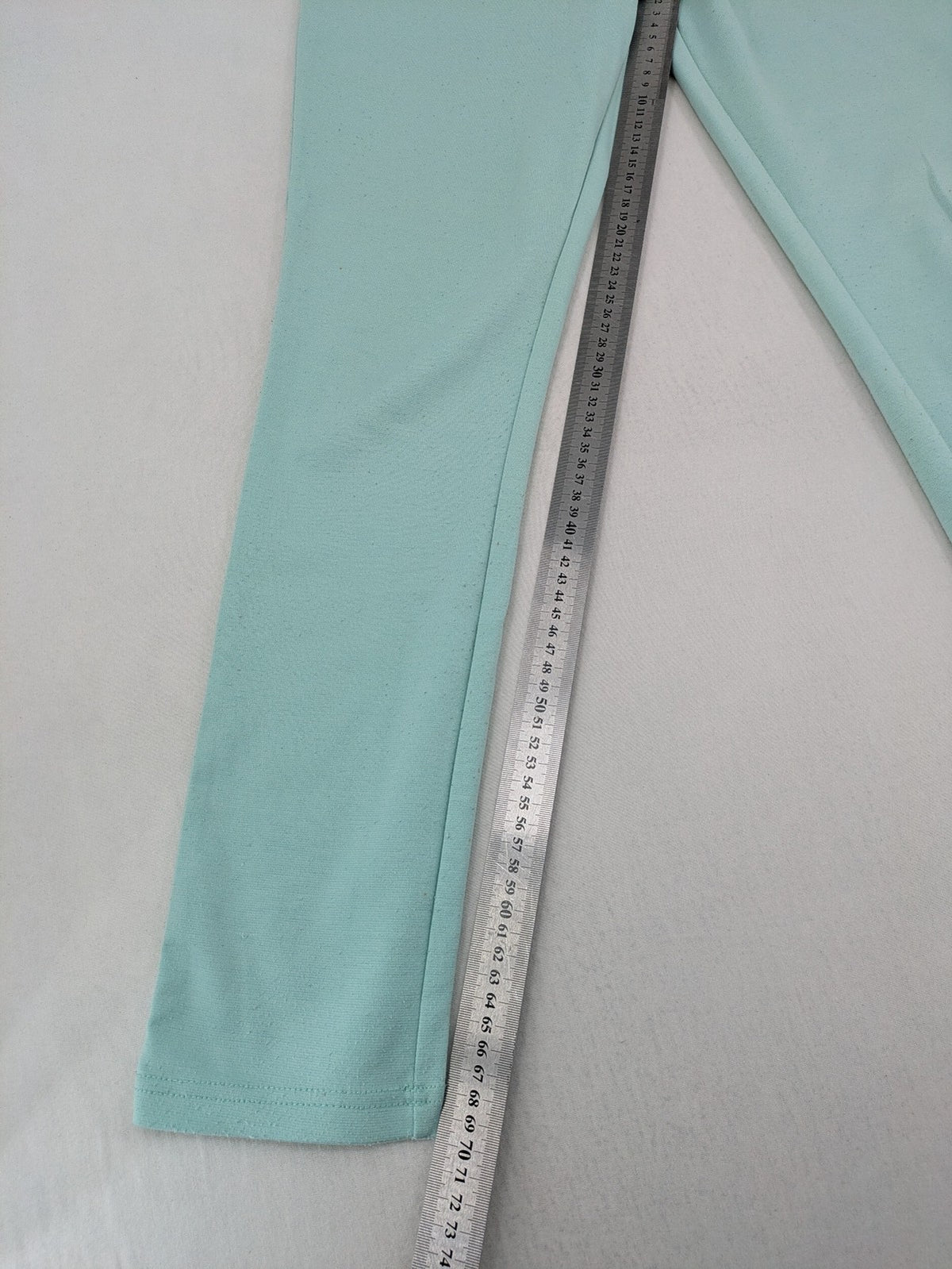 Dito green treggings with pull-on design, front pockets, and belt loops.
