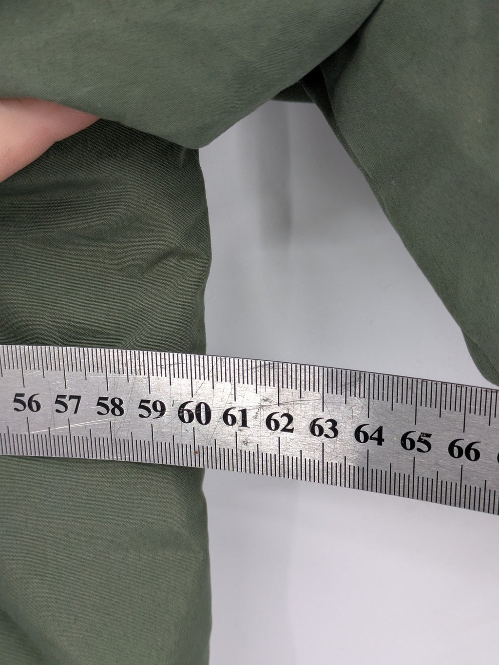 Bad Choices green parka coat with reflective details and logo patch on sleeve.