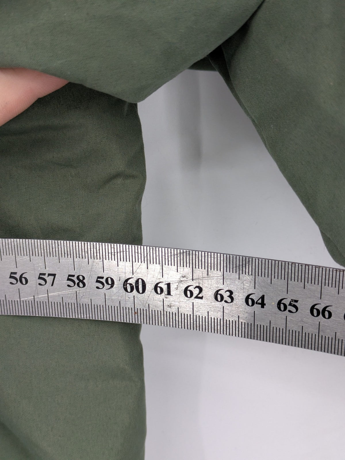 Bad Choices green parka coat with reflective details and logo patch on sleeve.