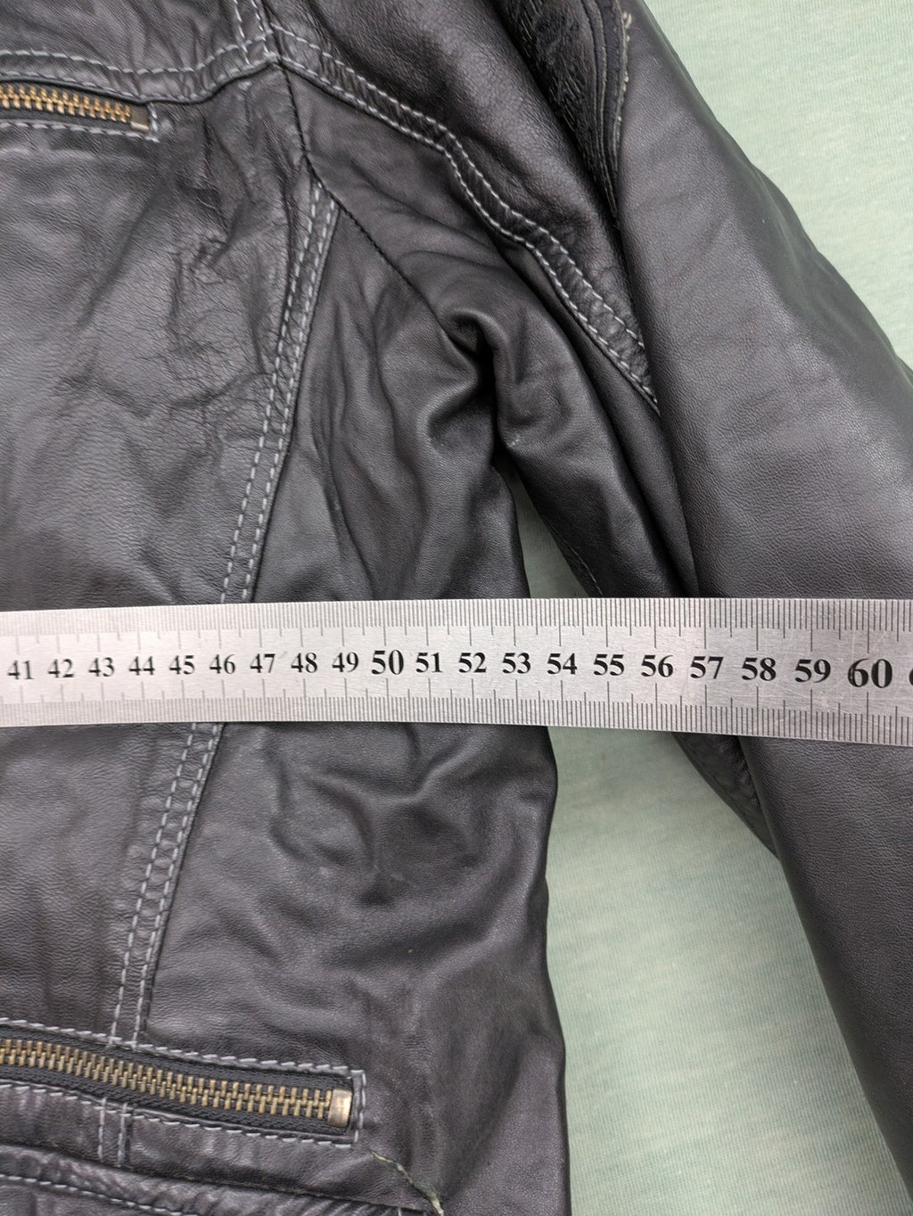 Tom Tailor black leather jacket vintage style with multiple pockets and contrast stitching.