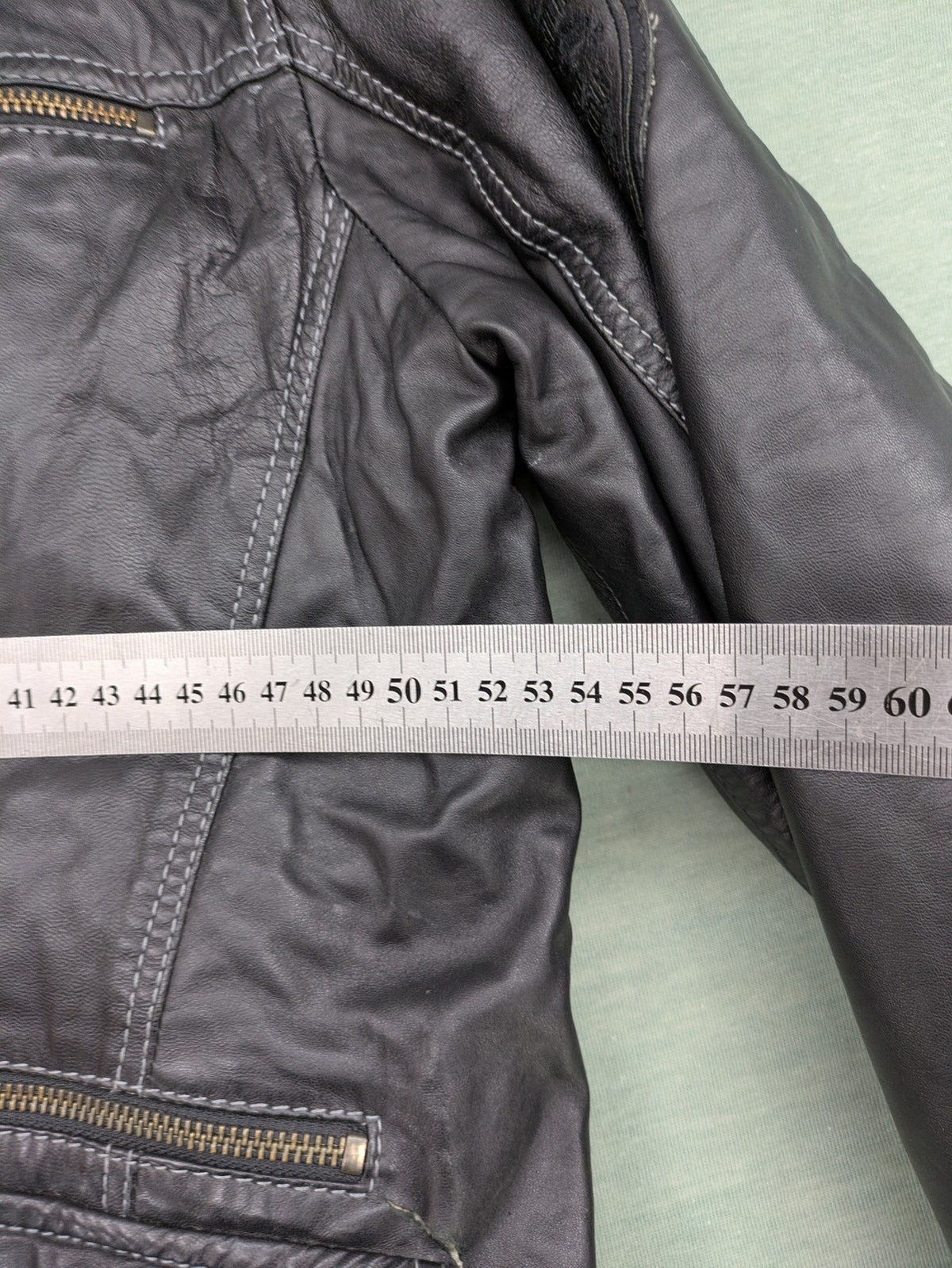 Tom Tailor black leather jacket vintage style with multiple pockets and contrast stitching.