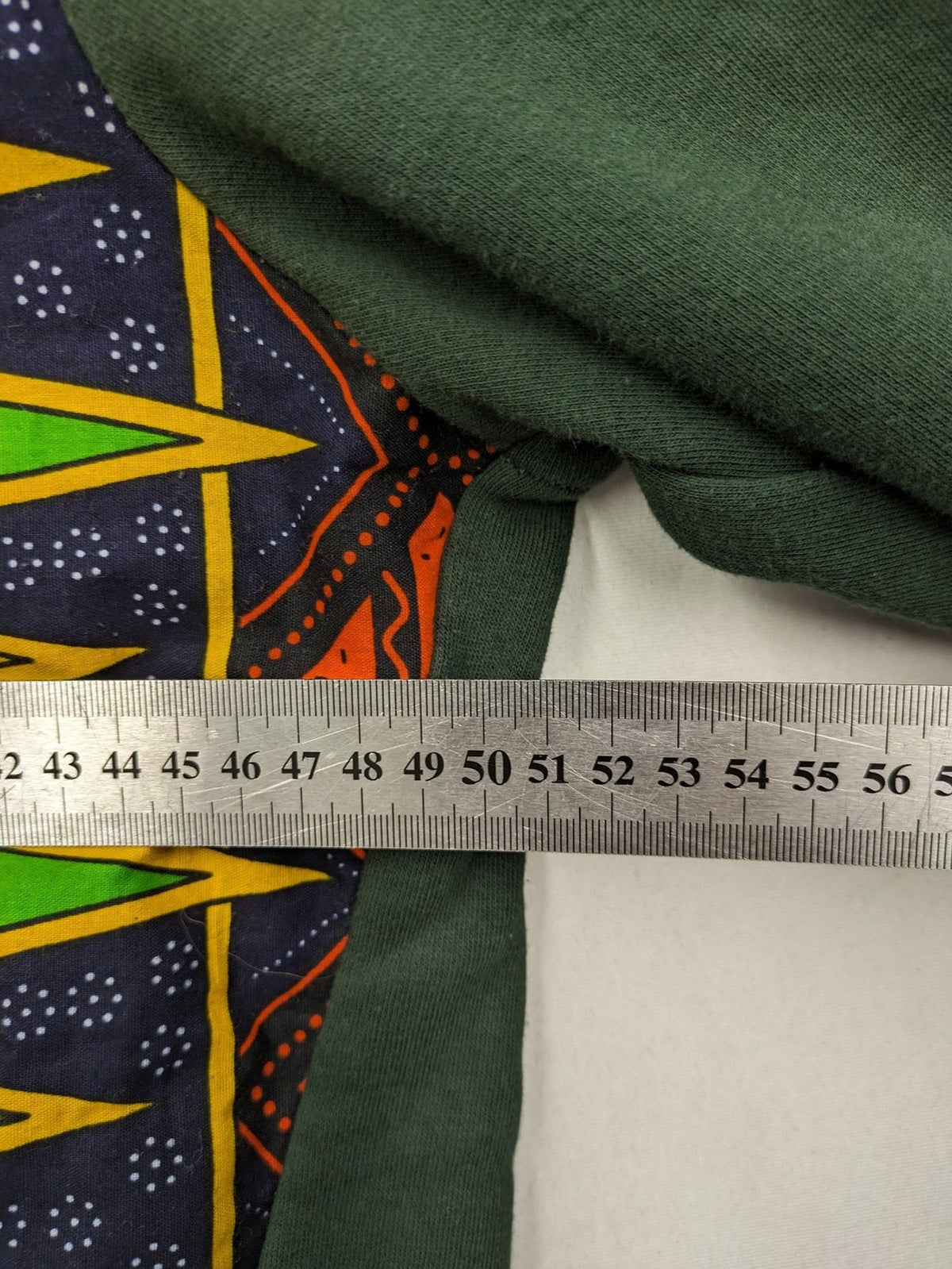Diweye Creations multi turtle neck jumper with vibrant African print and soft green material.