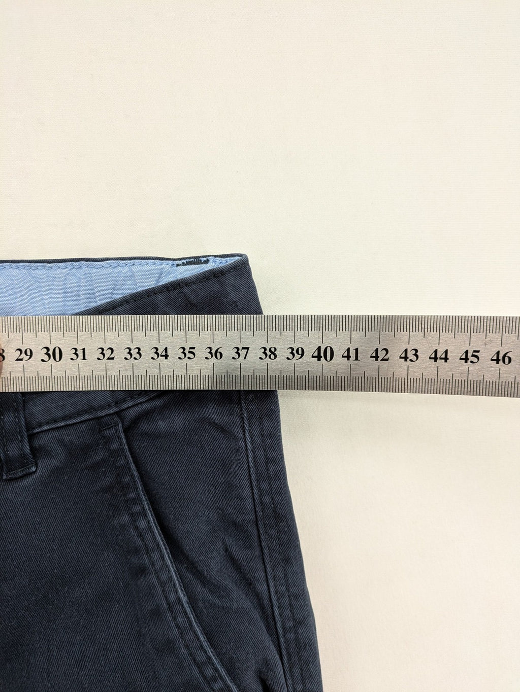 H&M navy chino pants with stretch, classic design, soft cotton blend material.
