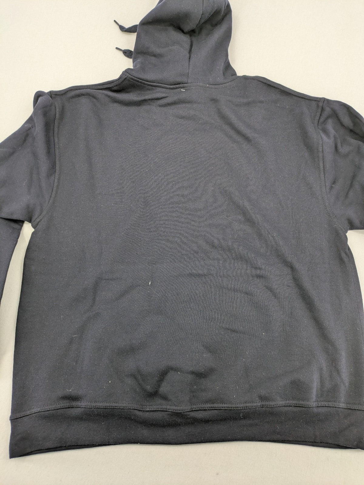 Trinkerbell black zip-through hoodie with blue graphic and adjustable drawstring hood.