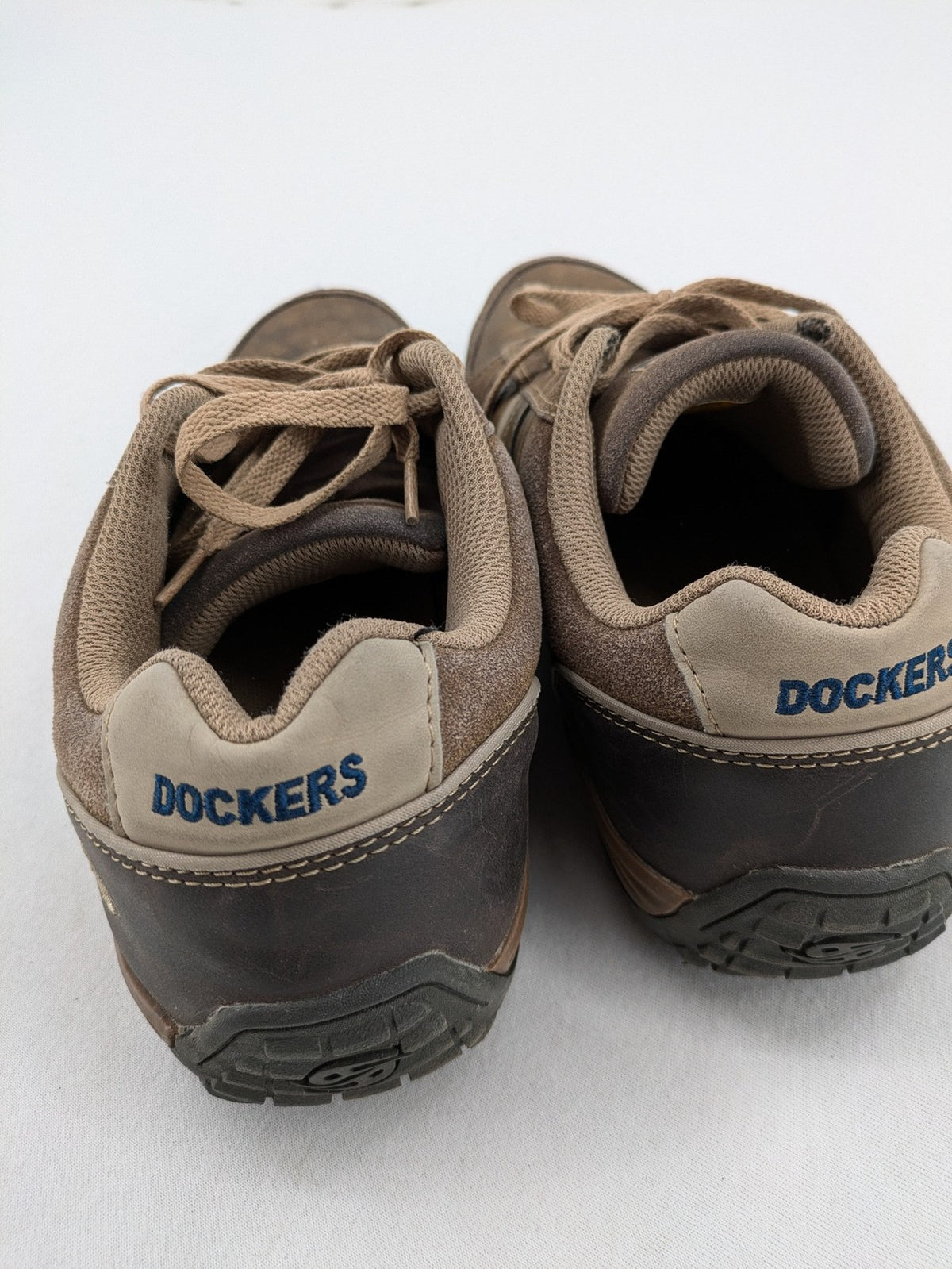 Dockers brown sneakers with subtle light brown and blue accents, lace-up design.