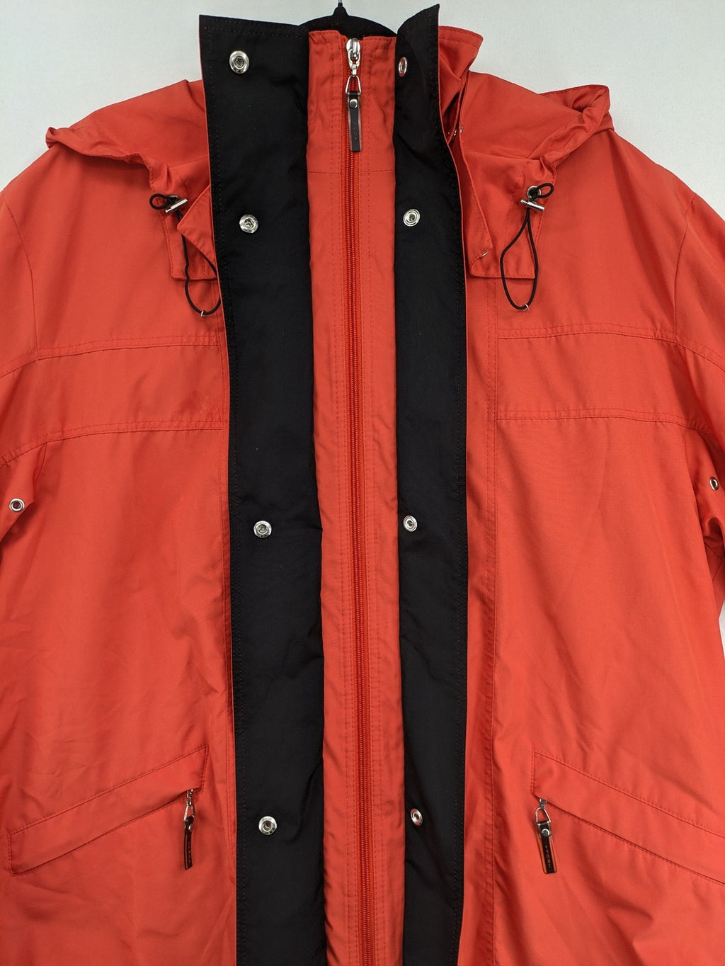 Sport Windbreaker orange jacket with adjustable hood, full zip, and button storm flap.