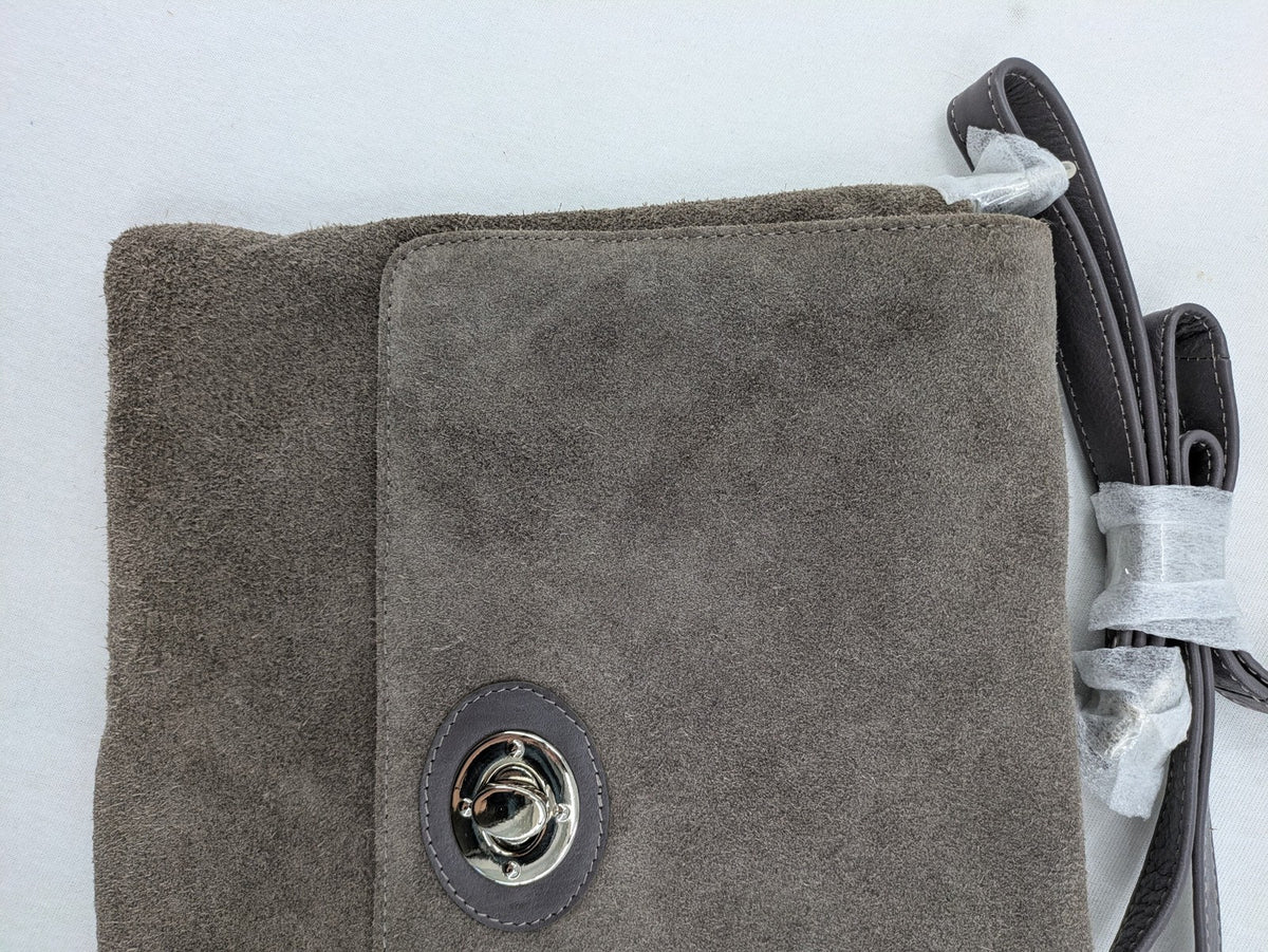 CNTMP grey suede crossbody handbag with flap and silver twist lock closure.