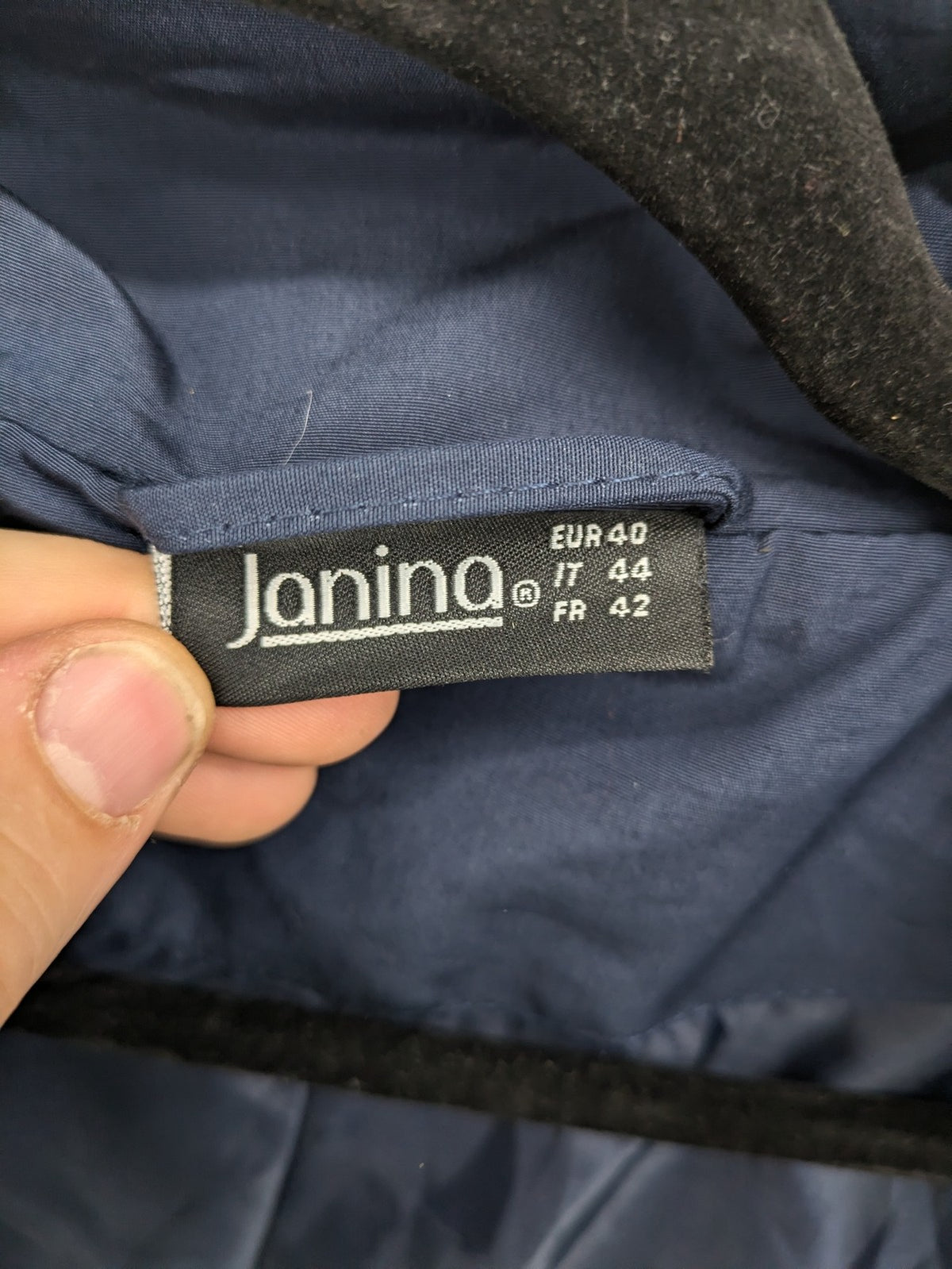 Janina navy anorak jacket with high collar and adjustable drawstring waist.