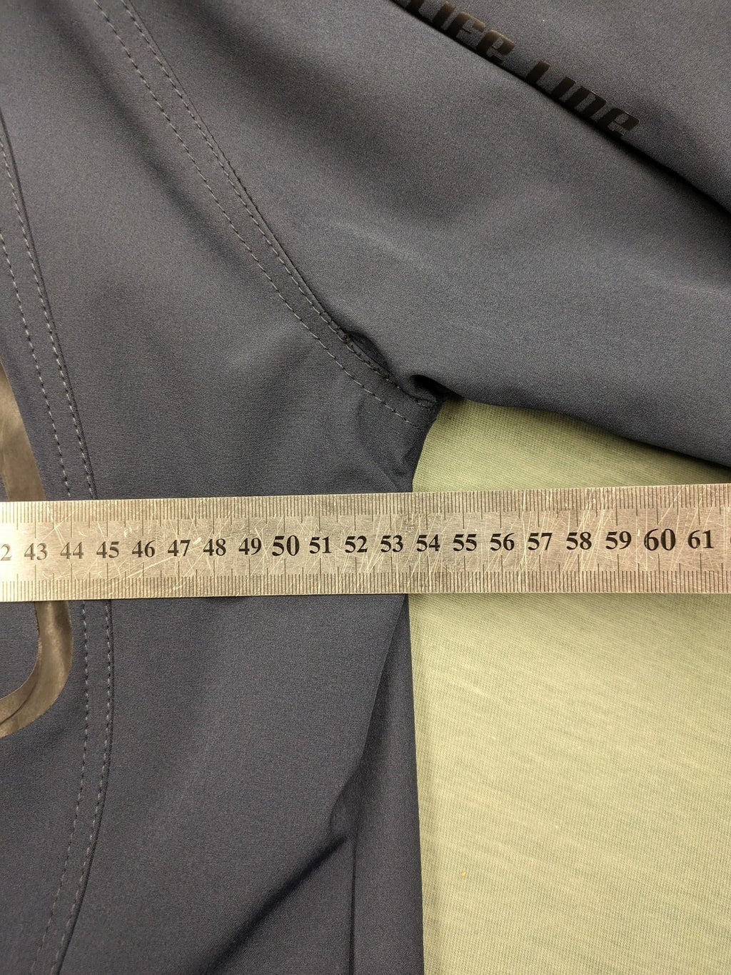 Life Line grey softshell jacket with adjustable hood and durable wind-resistant material.