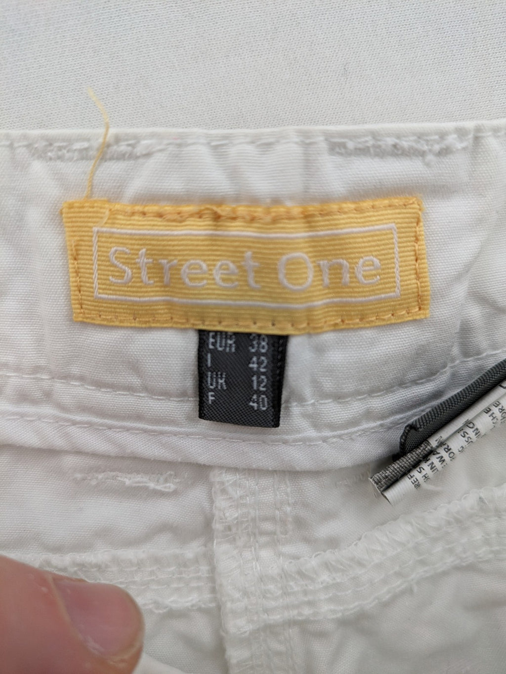 Street One white cargo pants with side pockets and wide leg design.