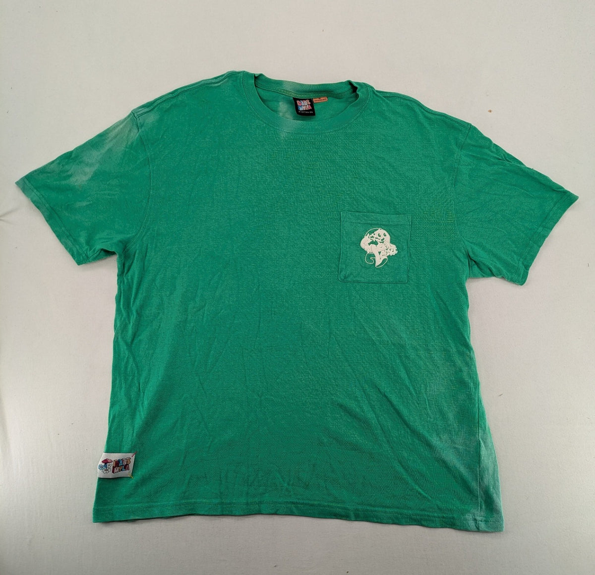 Myla green graphic t-shirt with large peace earth print and front pocket design.