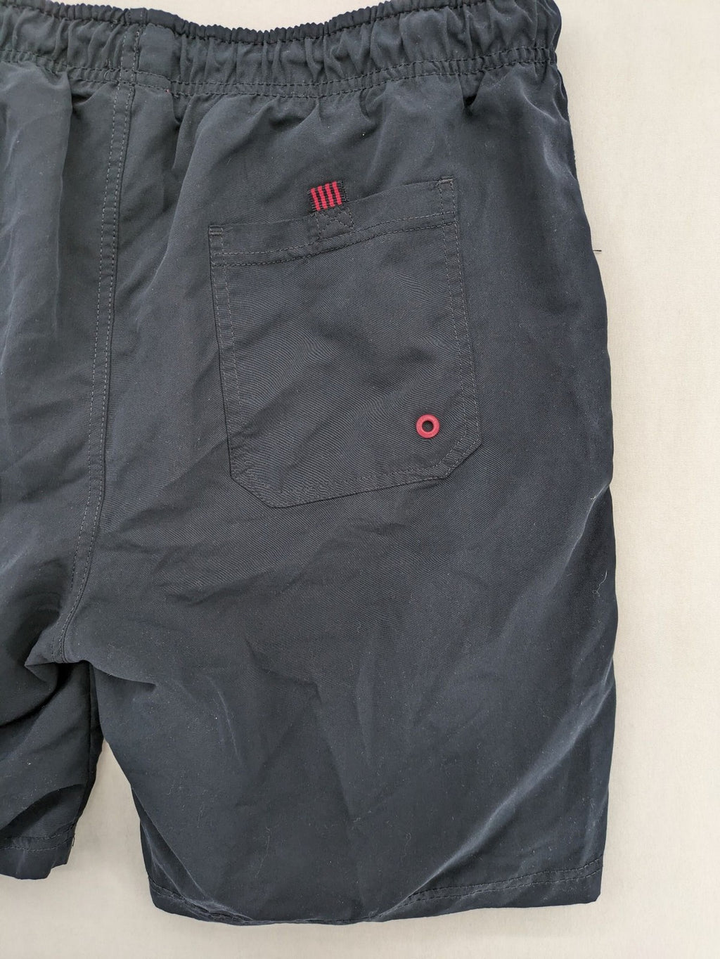 LC Waikiki navy swim shorts with red accents, elastic waistband, and quick-dry material.