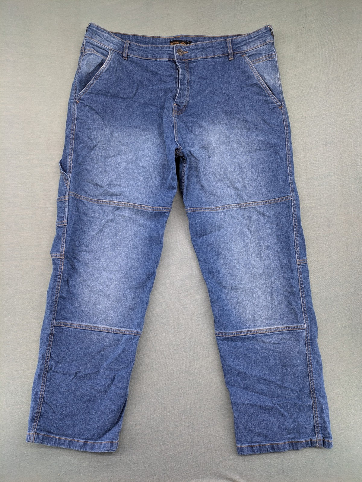 Bench blue straight jeans with reinforced knees and multiple cargo pockets.