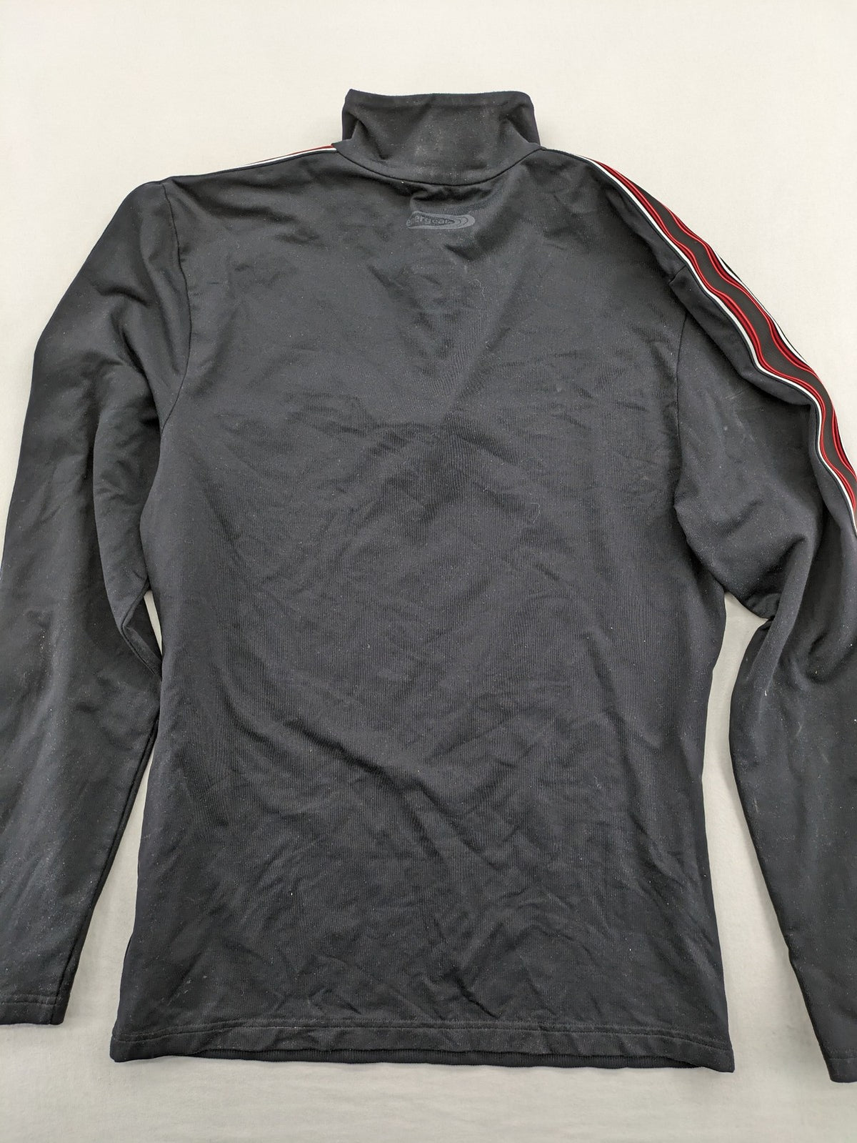 Bogner black turtle neck jumper with red and white striped sleeves and 1/4 zipper.