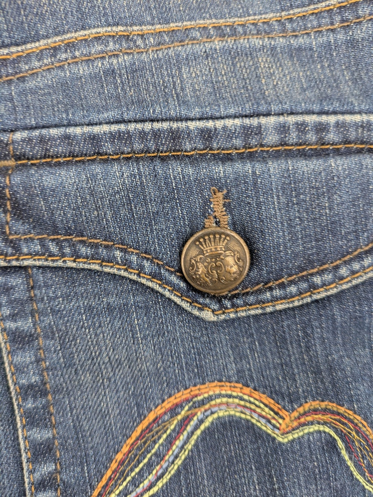 Rosner blue wide leg jeans with colorful embroidery on back pockets.