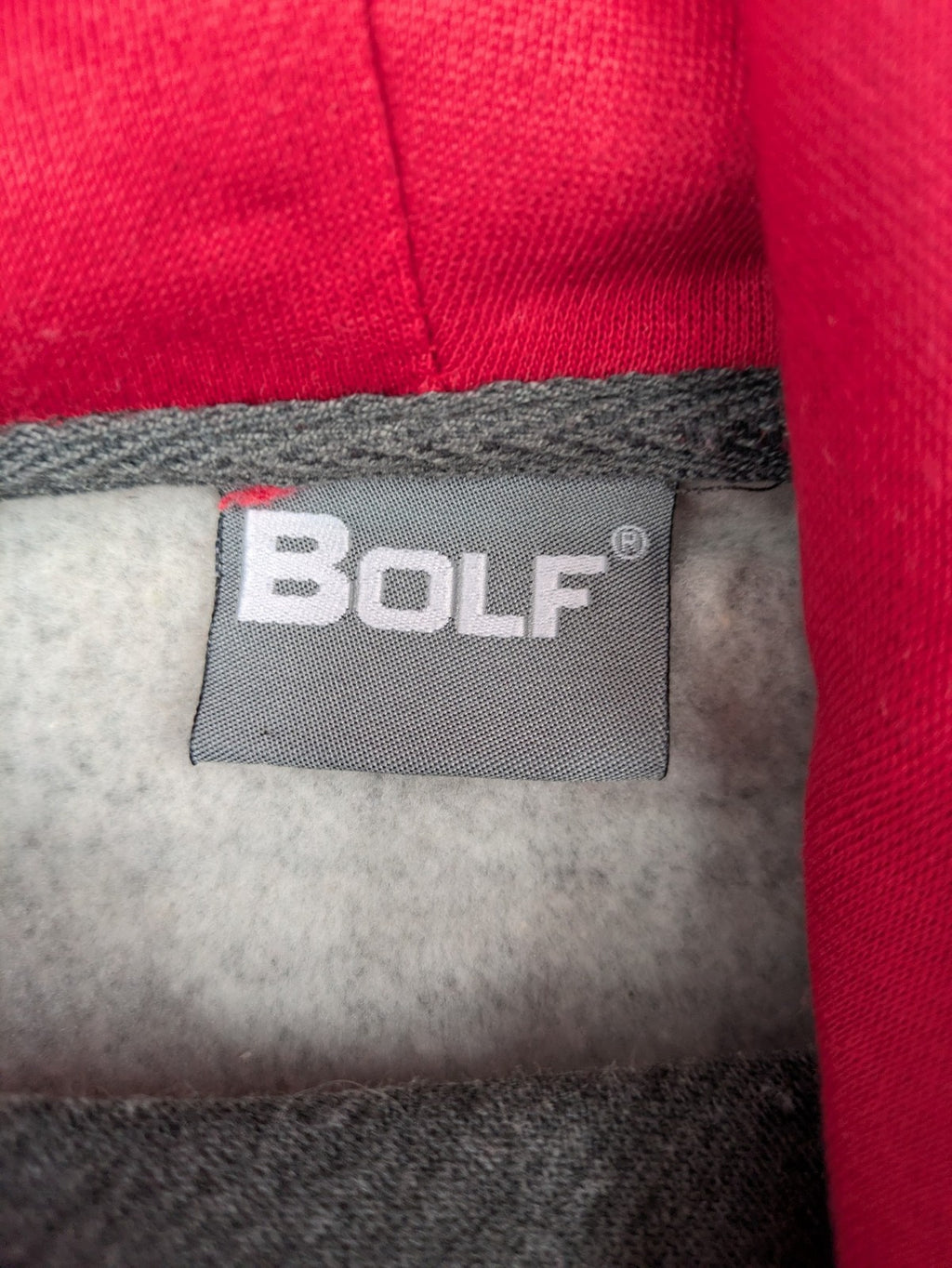 Bolf grey hoodie with pink contrast hood, kangaroo pocket, and ribbed cuffs.