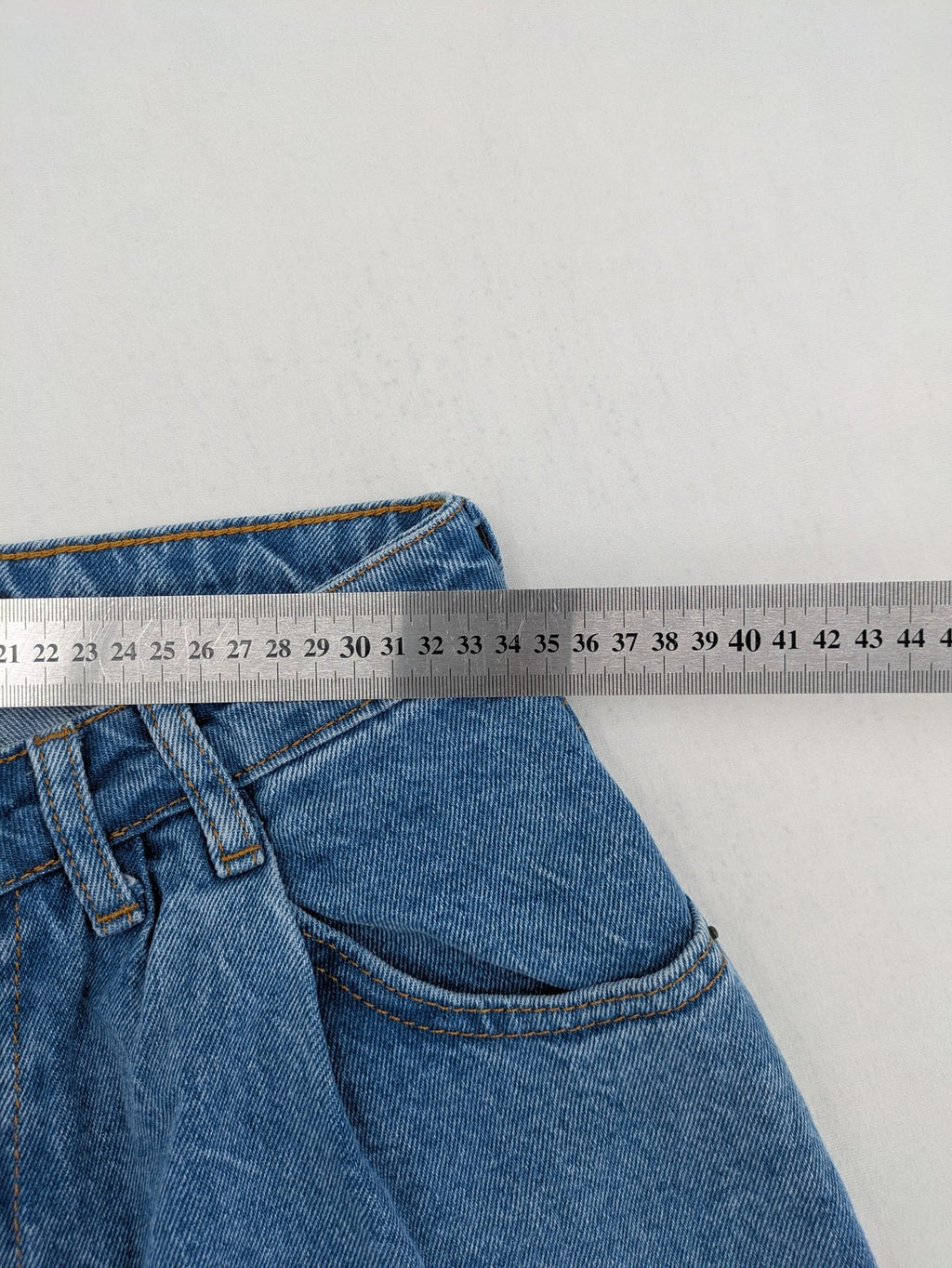 X.LOVE blue high waist wide leg jeans with front pleats and frayed hem.