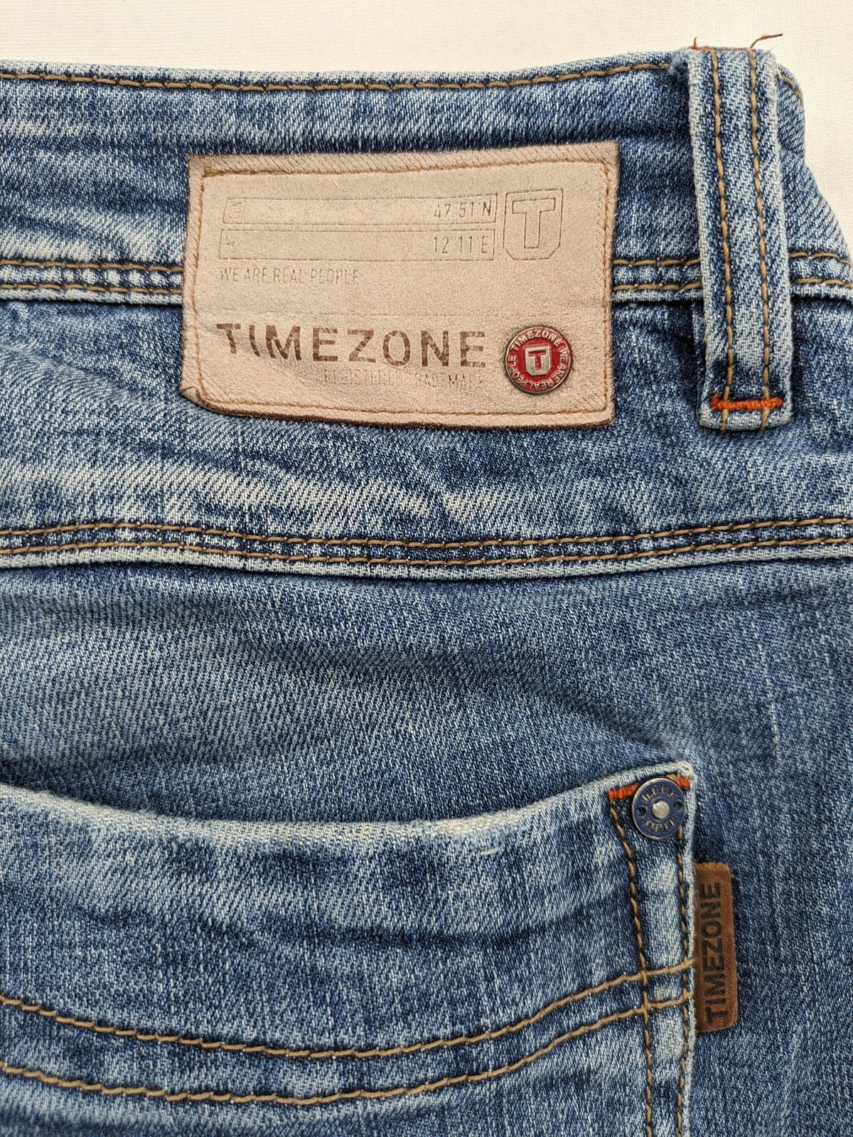 Timezone blue straight jeans slim fit with checkered pattern lining and button fly.
