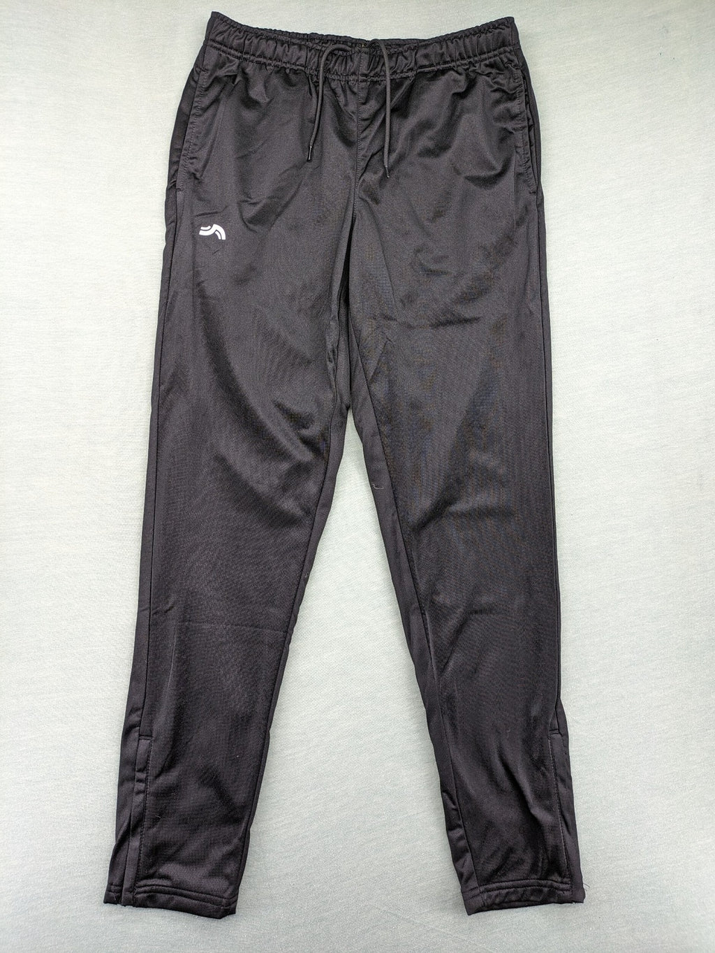 Crivit black weighted training pants with elastic waistband, side pockets, and zippered cuffs.