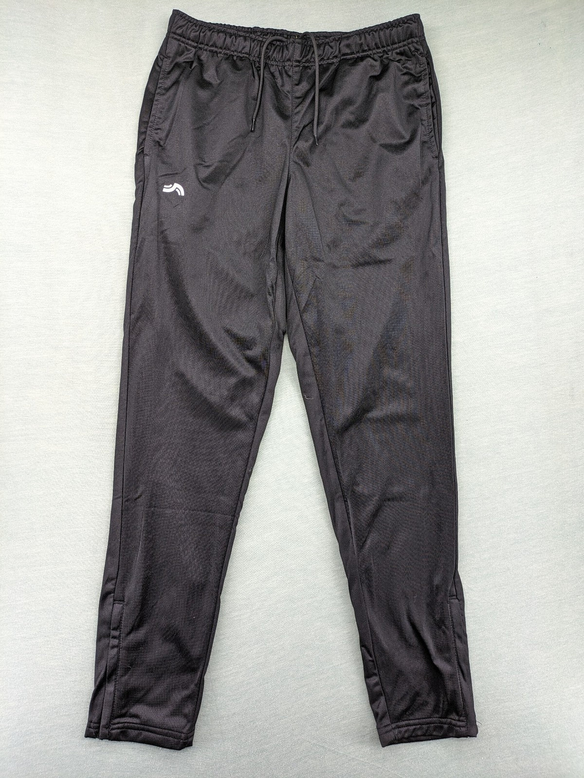Crivit black weighted training pants with elastic waistband, side pockets, and zippered cuffs.