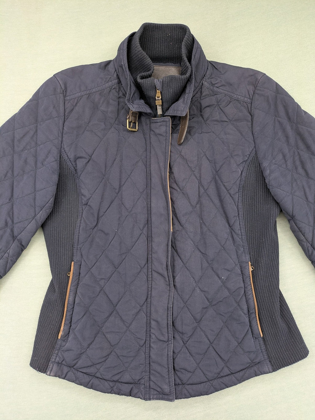 Massimo Dutti black quilted jacket with contrasting brown trim and ribbed side inserts.