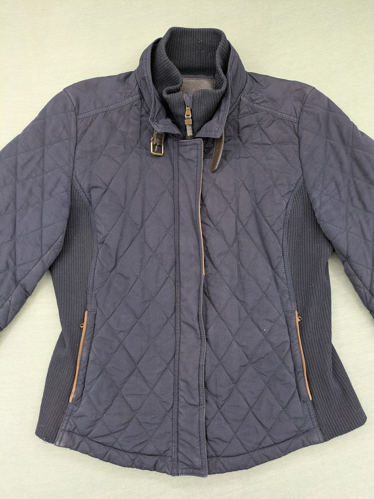 Massimo Dutti black quilted jacket with contrasting brown trim and ribbed side inserts.