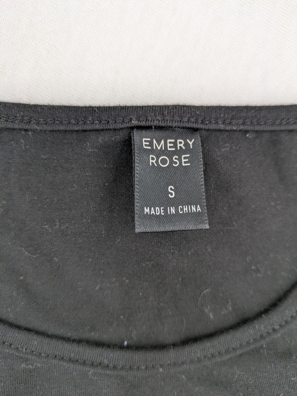 Emery Rose pink T-shirt with floral raglan sleeves and round neckline.