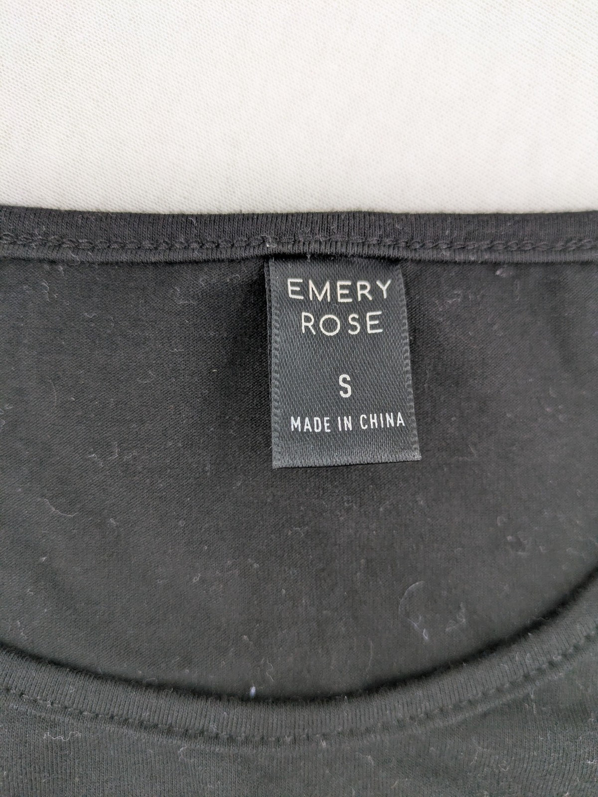 Emery Rose pink T-shirt with floral raglan sleeves and round neckline.