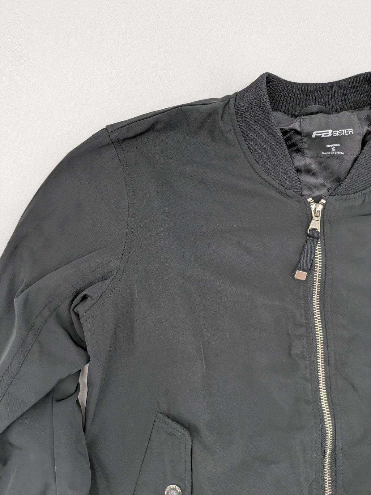 FB Sister grey bomber jacket with full zip, ribbed cuffs, and smooth polyester material.