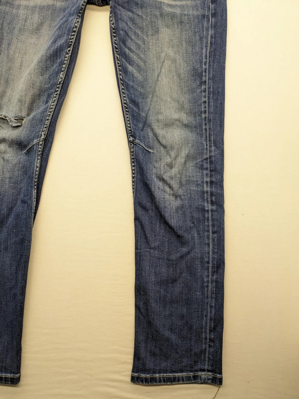 WAM Denim blue straight jeans with distressed details and button fly.