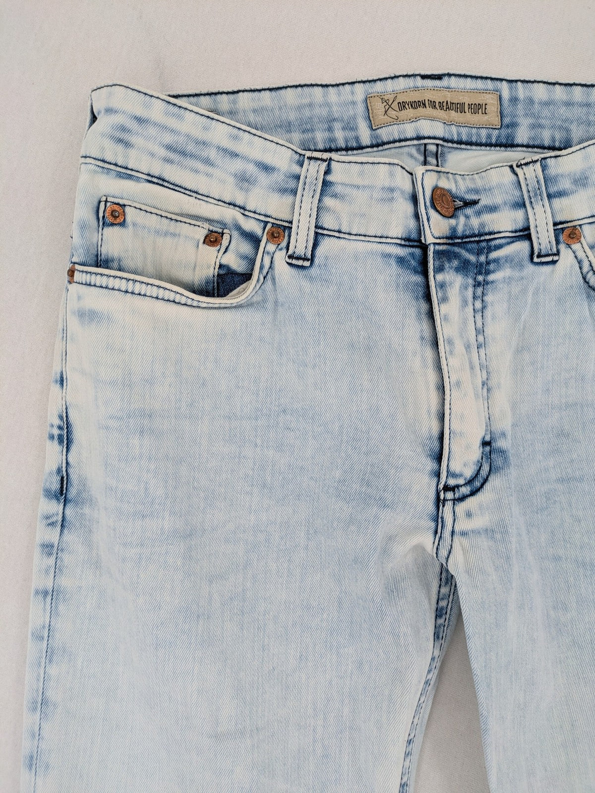 Drykorn blue slim fit jeans with acid wash and leather logo patch.