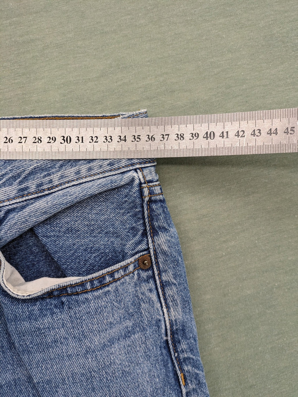 Re/Done blue straight jeans high rise with button fly and raw hem detail.