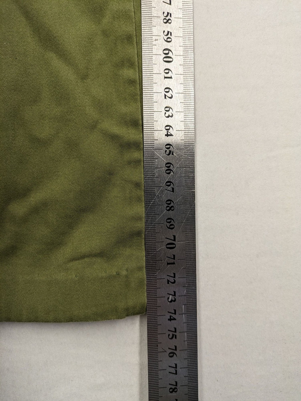 BRAX khaki pants classic five-pocket style with logo patch and zip button closure.