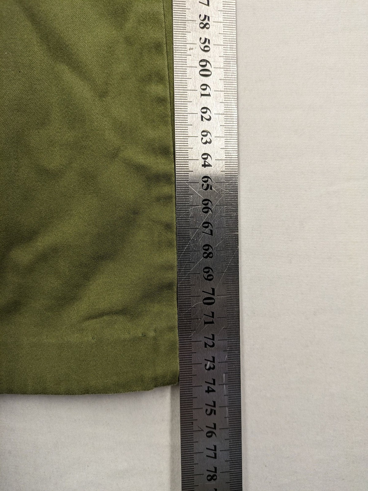 BRAX khaki pants classic five-pocket style with logo patch and zip button closure.