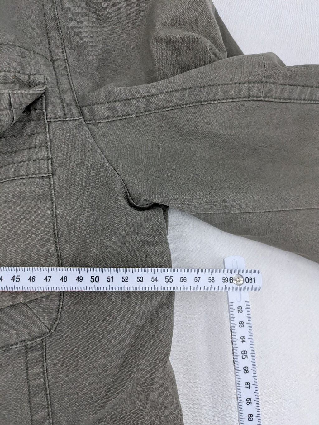 Walbusch khaki military jacket with checkered blue-white lining and multiple pockets.