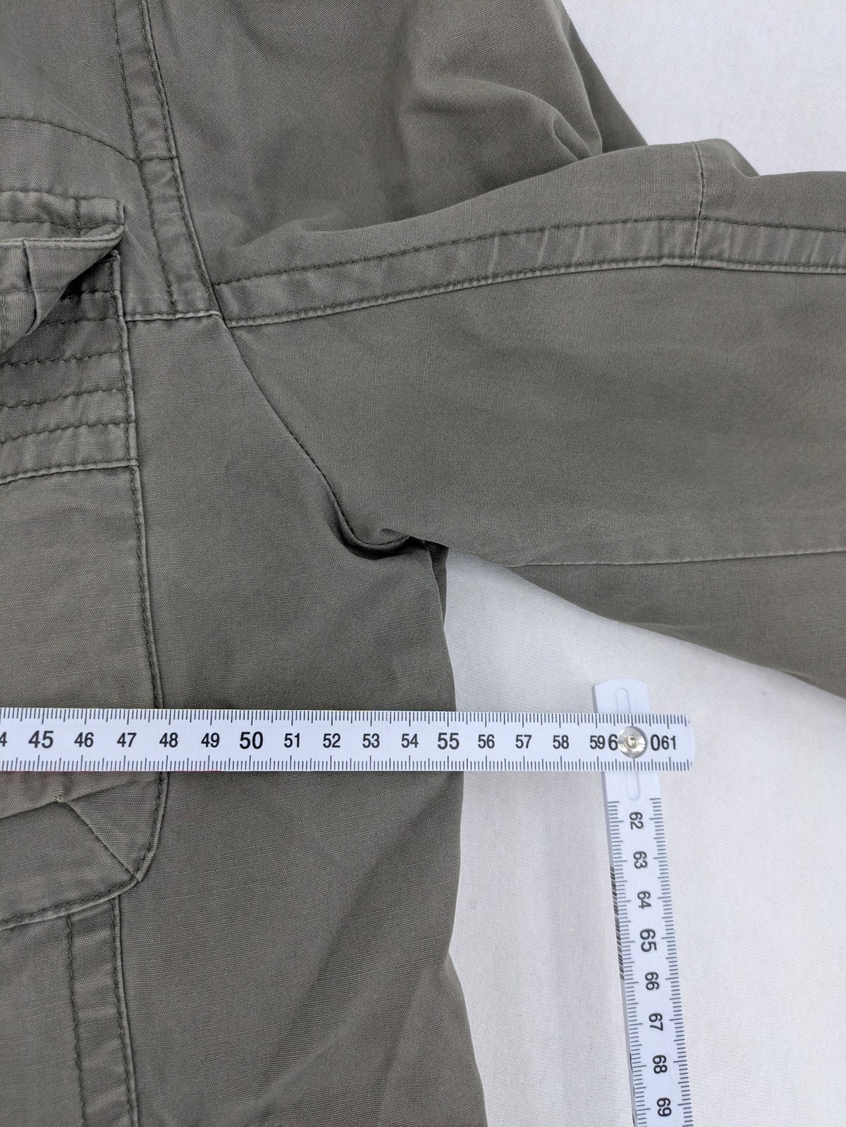Walbusch khaki military jacket with checkered blue-white lining and multiple pockets.