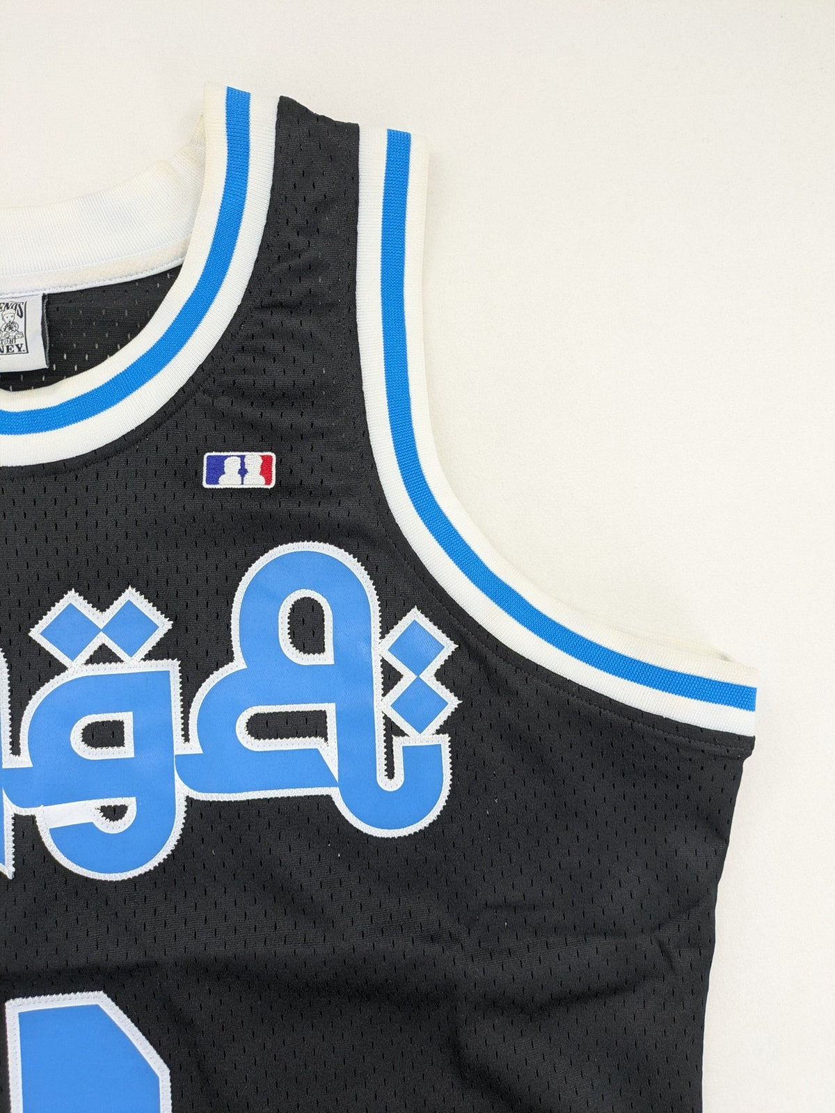 Friends With Money blue basketball jersey black mesh with stylized graphic and number "1