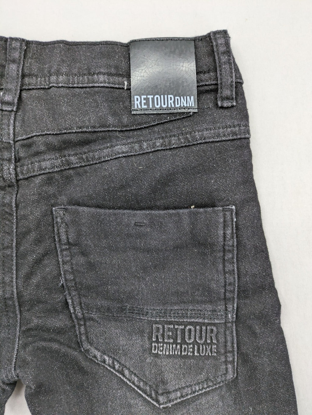 Skinny black straight jeans with distressed details and logo, made from durable denim.