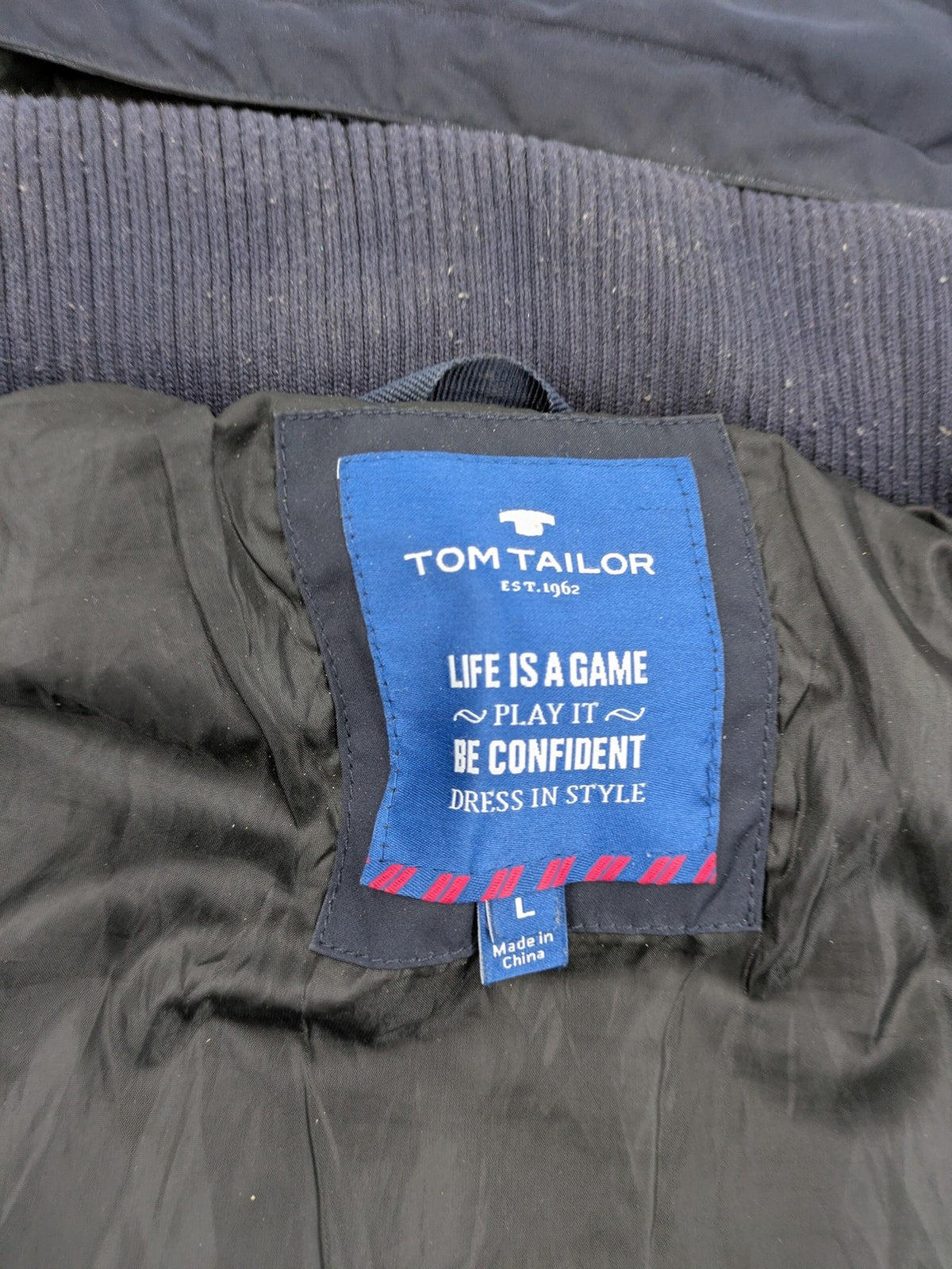 Tom Tailor navy puffer jacket with quilted design and adjustable hood, featuring multiple pockets.
