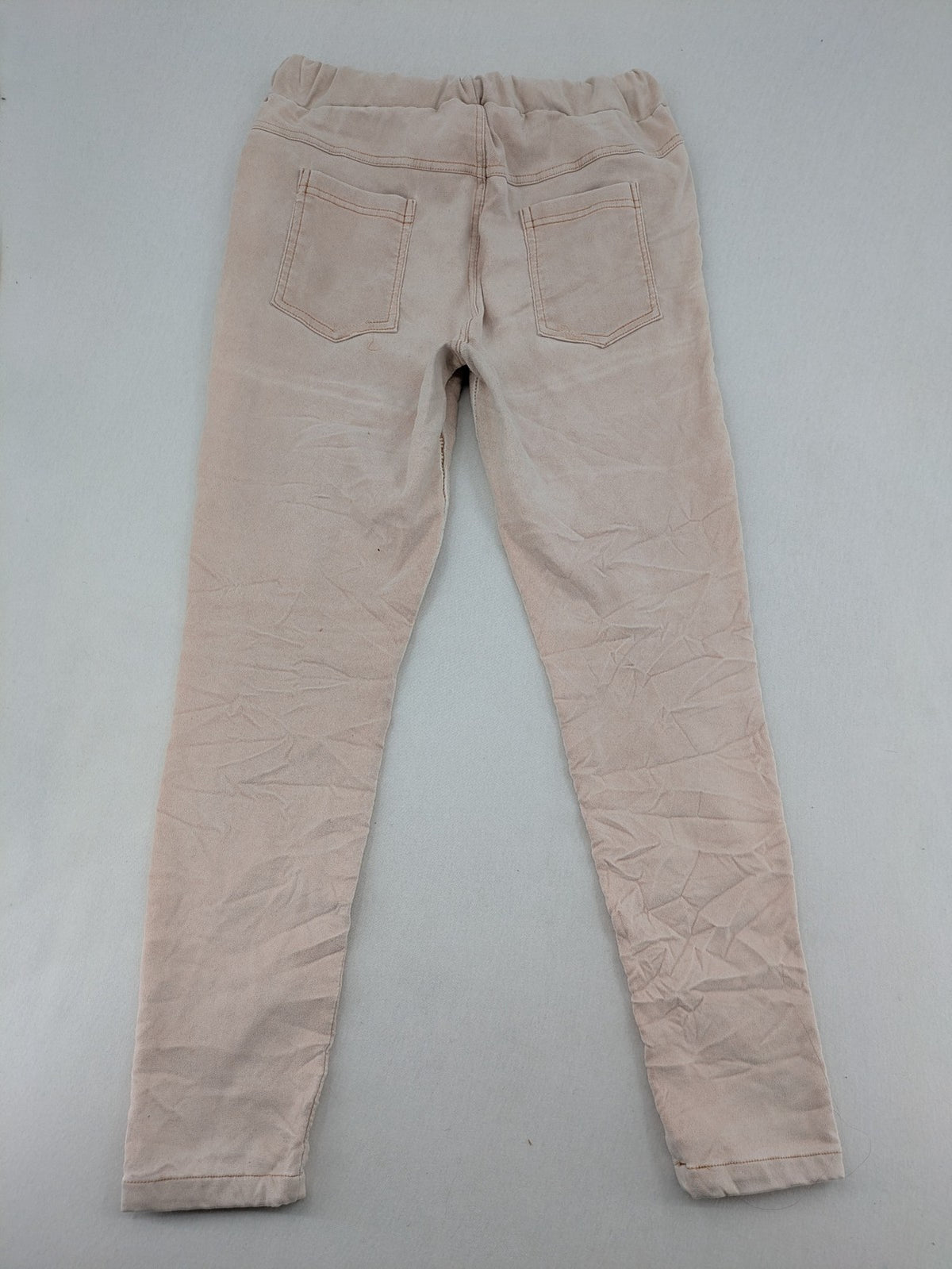 Made In Italy beige pants with crinkle texture and rock-style patches, drawstring waist.