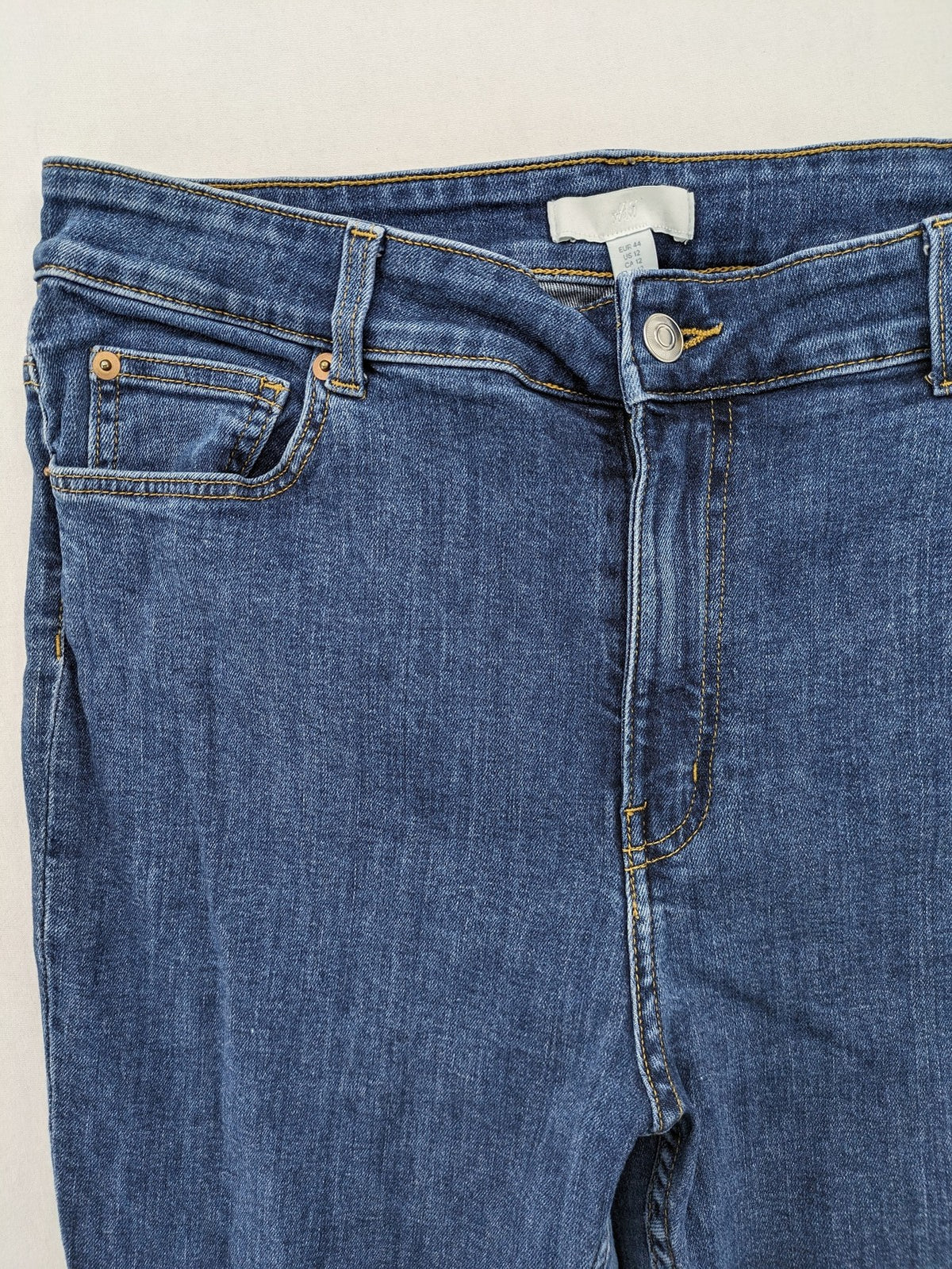 H&M blue skinny jeans with stretch denim and slim fit design.