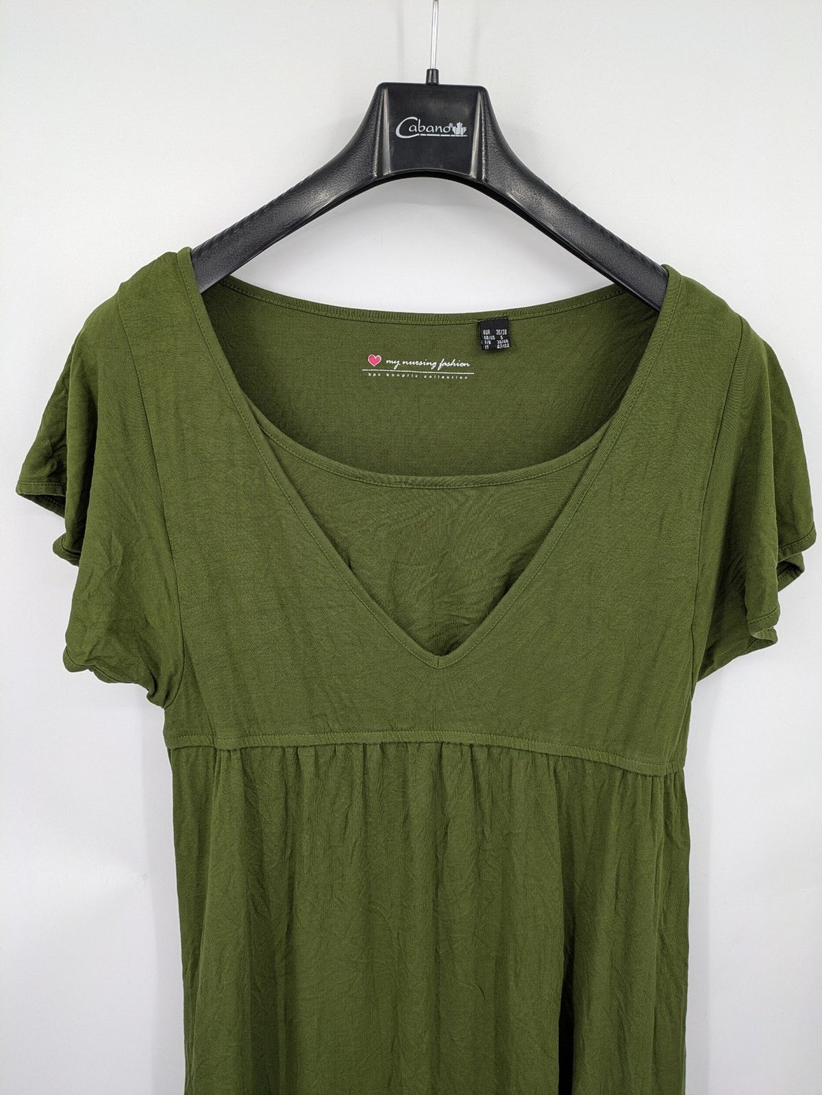Bonprix green maternity dress with layered V-neck and empire waist design.