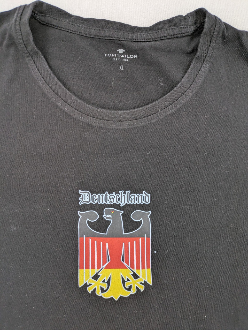 Tom Tailor black T-shirt with Germany eagle crest and flag colors, 100% cotton.