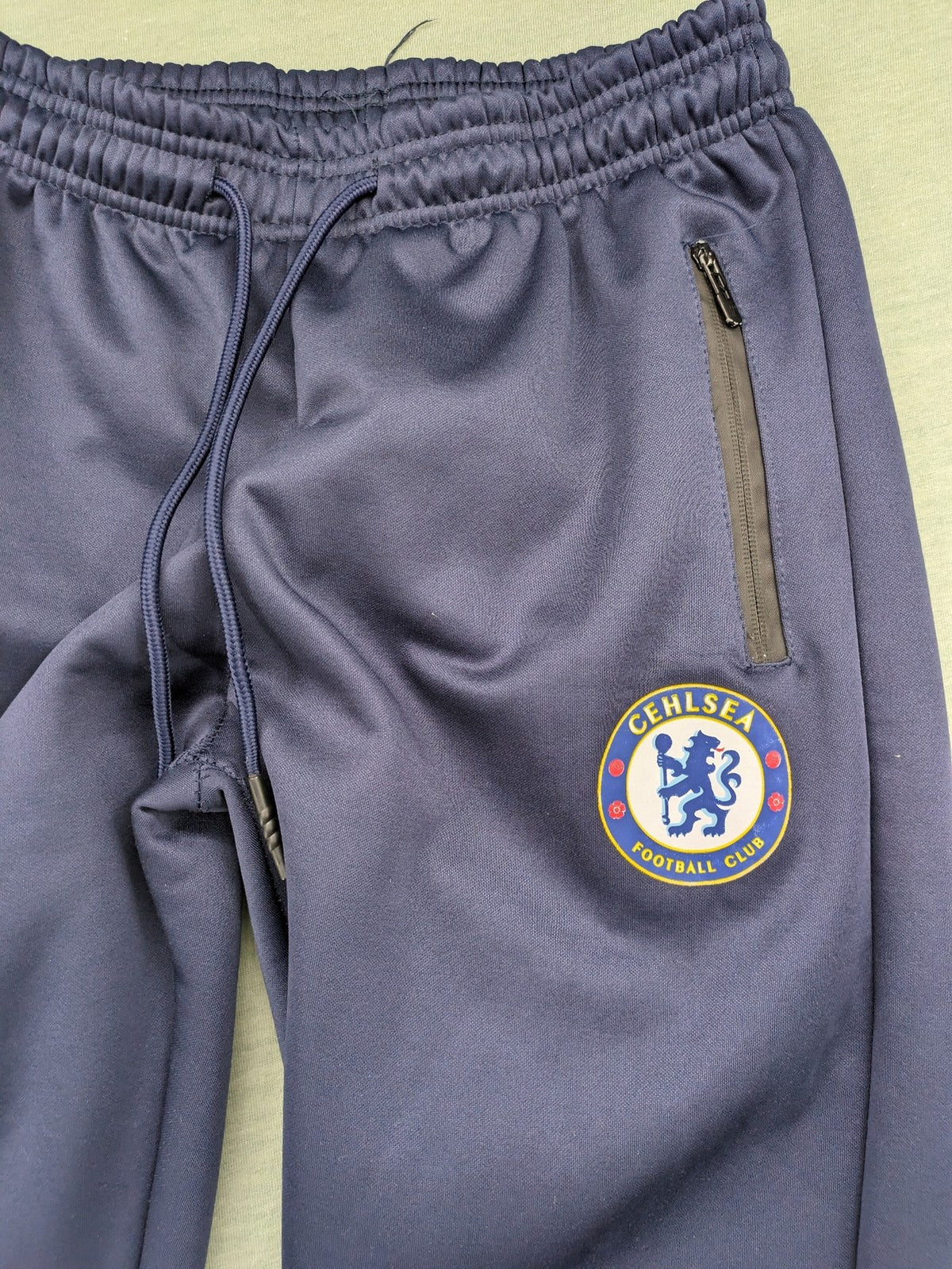 Chelsea FC grey and navy tracksuit set with full zip hoodie and three logos.