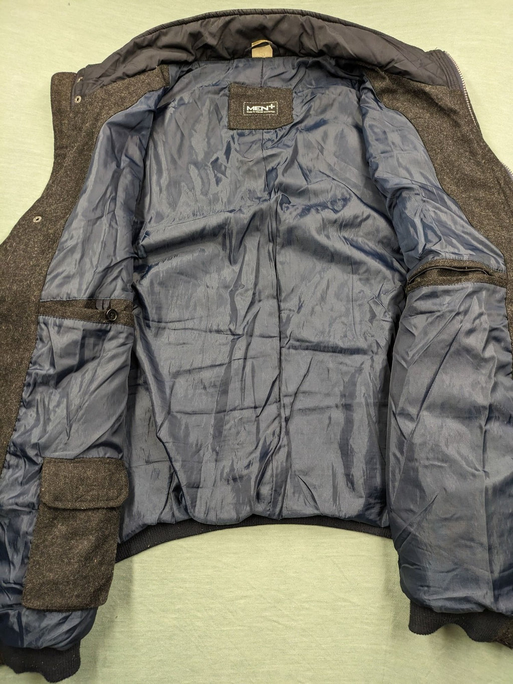 Men Plus grey and navy quilted vest with full zip and snap button placket.