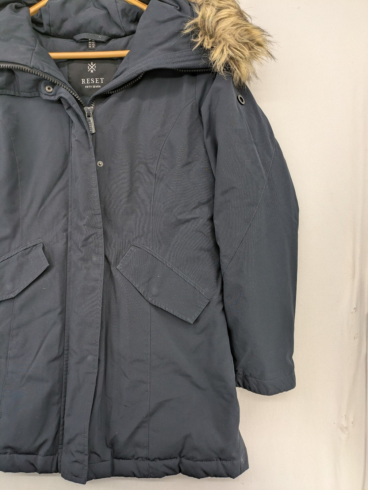 Reset Fifty Seven cream puffer coat with faux fur hood and down insulation.