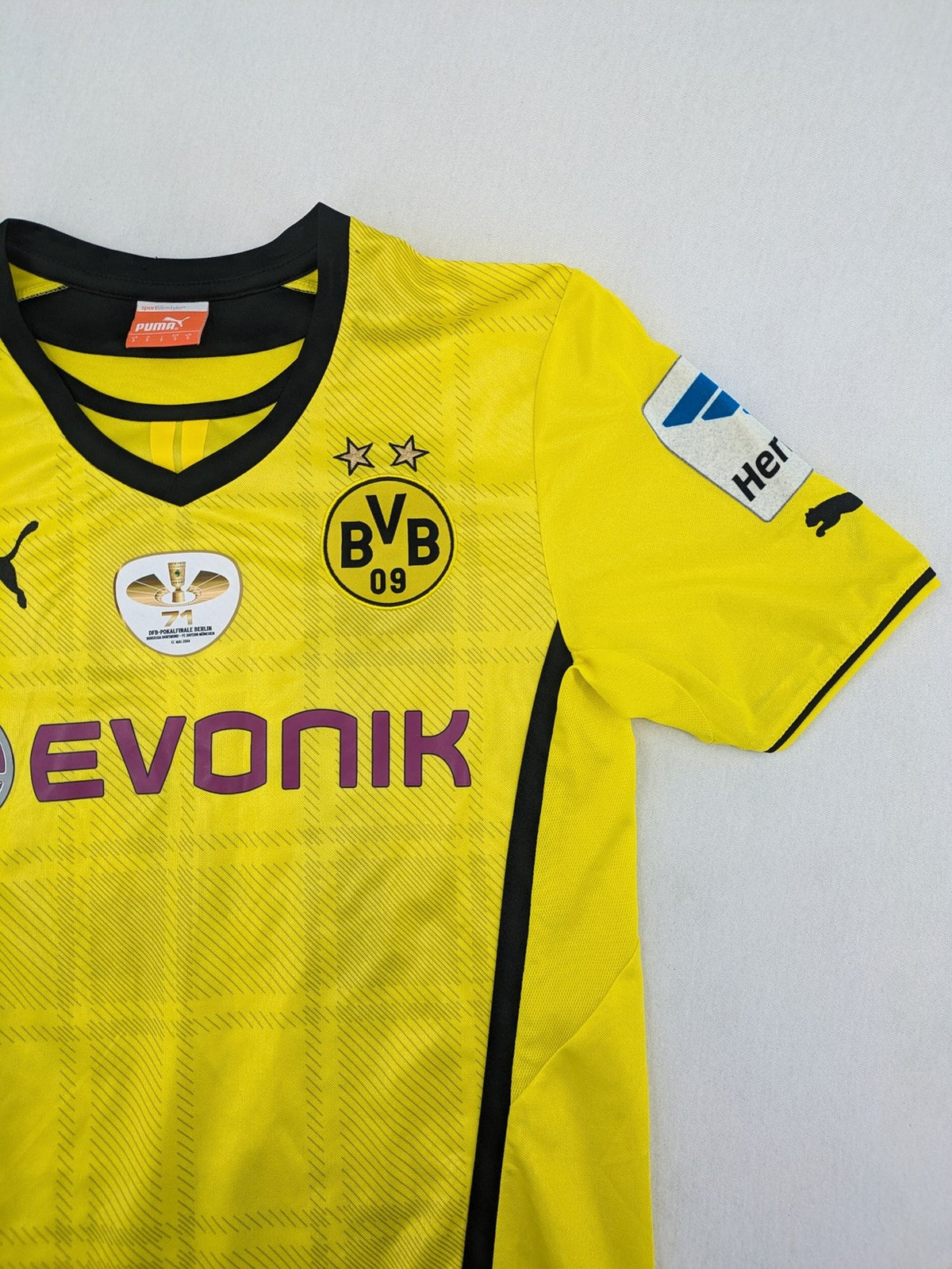 Borussia Dortmund black and yellow soccer uniform with DFB Pokal 2014 patch and Puma logo.