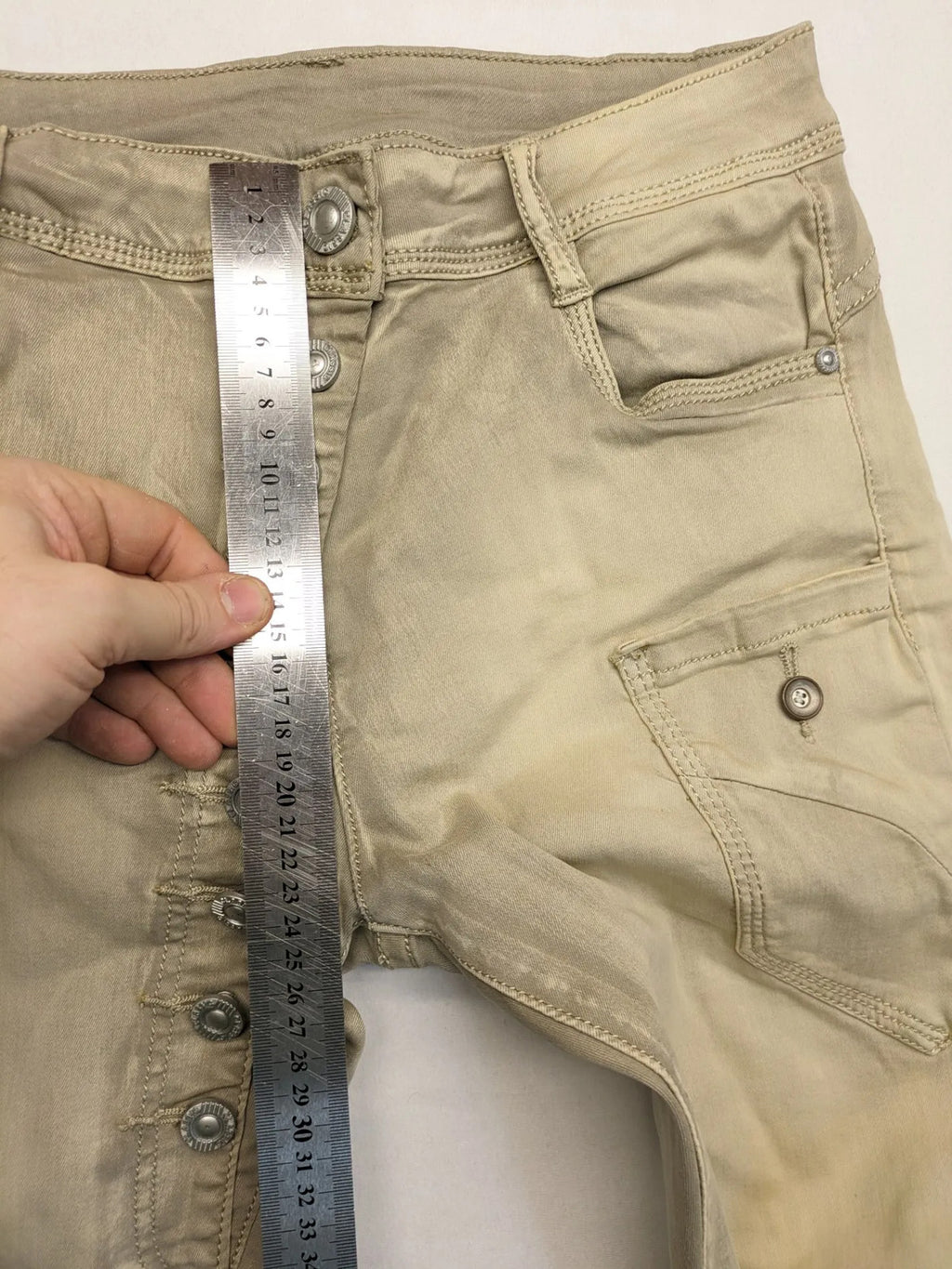 Mozaar beige straight jeans with unique asymmetrical button placket and practical pockets.
