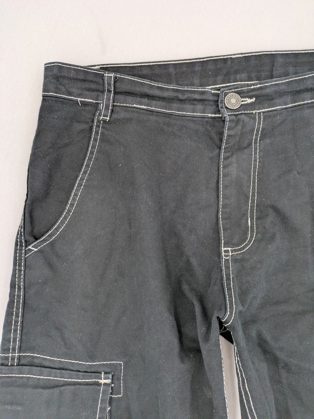FSBN black baggy cargo pants with white contrast stitching and multiple pockets.